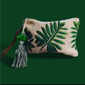 Cloth wristlet featuring green floral designs.